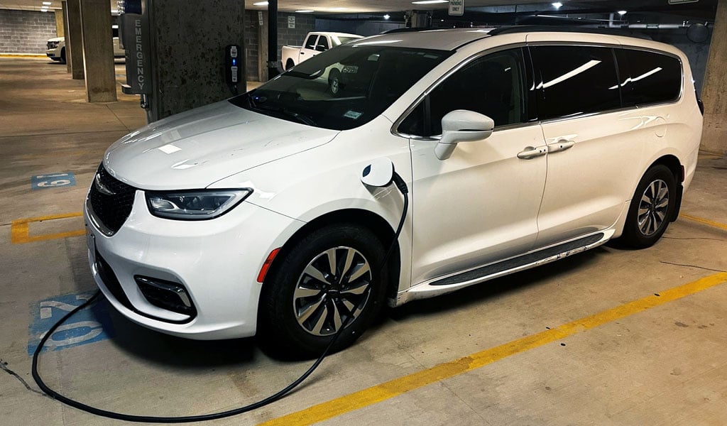 An electric vehicle charges in a fuel-efficient vehicle–only parking area, supporting cleaner transportation.