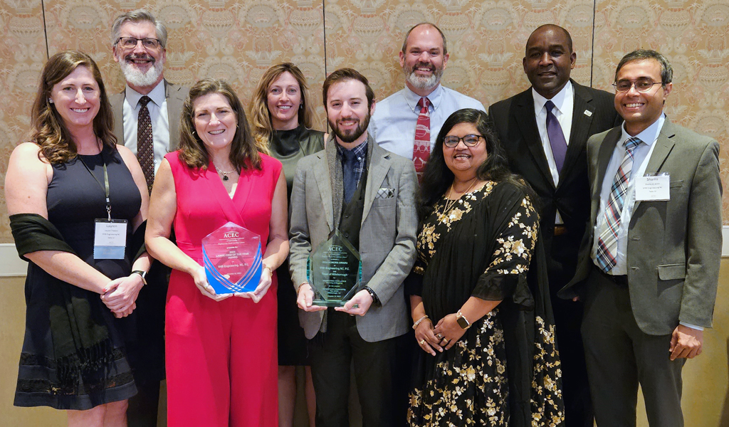 A group of VHBers smile at the camera in a group photo with the awards at the ACEC/NC Awards Gala.