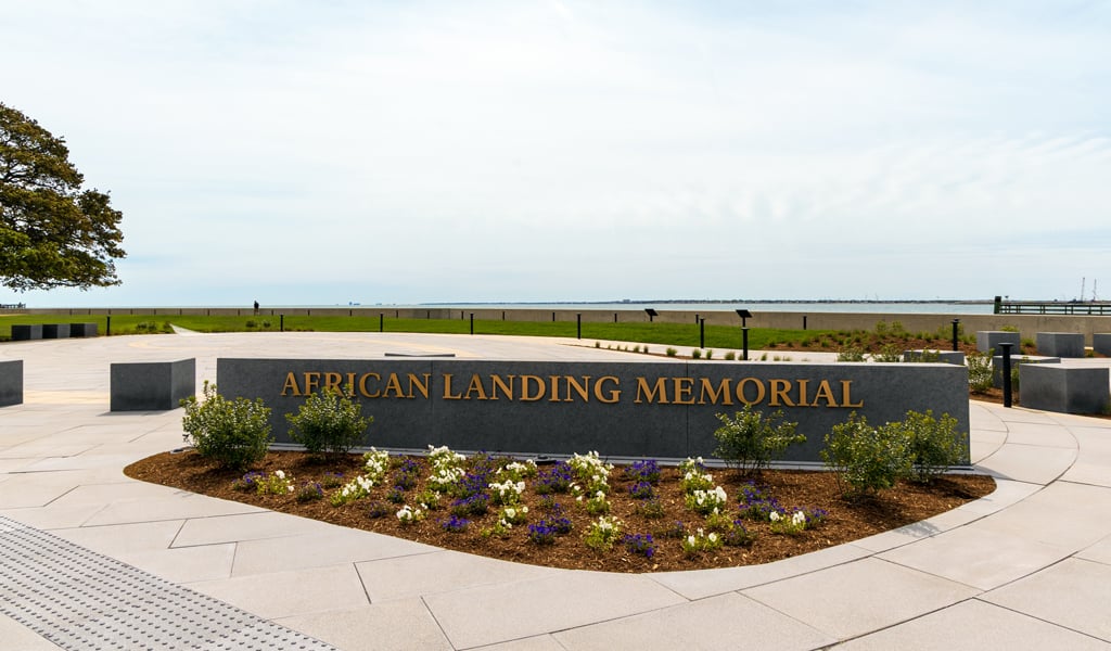 Stone marker reading “African Landing Memorial” set within a circular plaza overlooking the Chesapeake Bay at Fort Monroe.