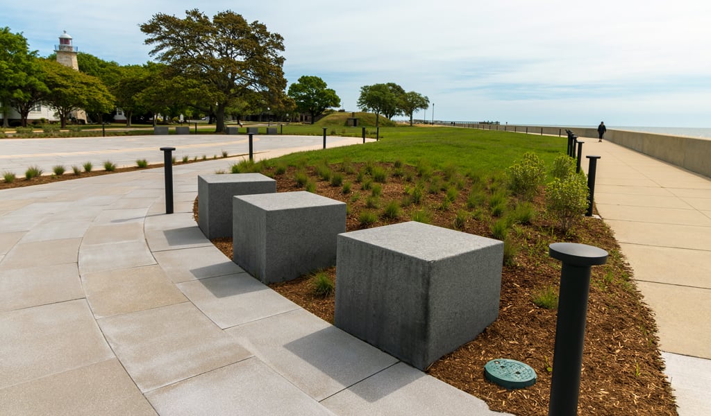 Seating blocks and curved walkways within the African Landing Memorial landscape near the Fort Monroe waterfront.