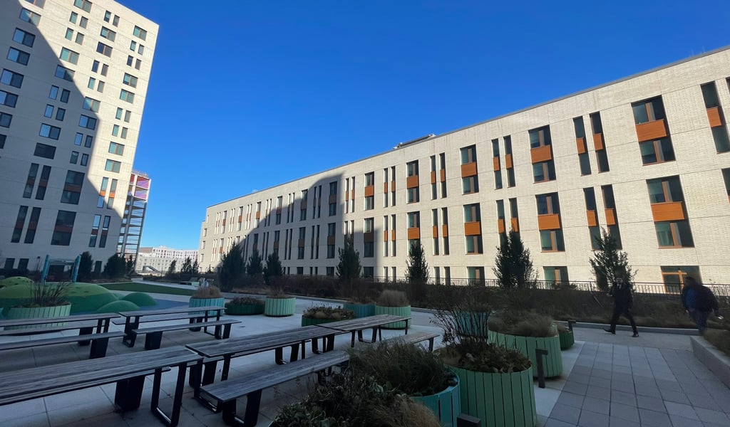 Large building with multiple windows surrounded by blue skies.