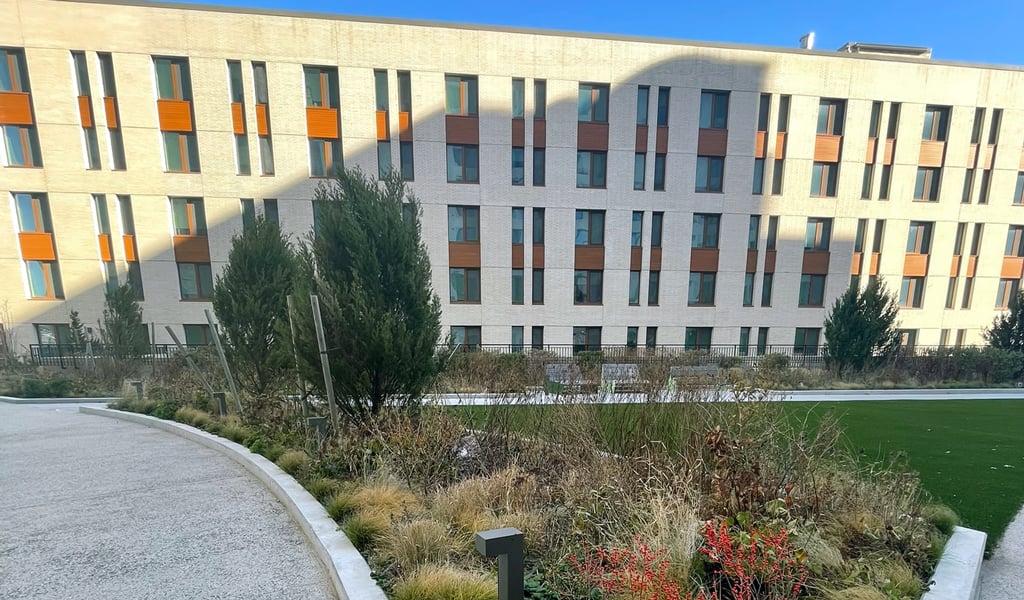 Large building with windows and blue skies.