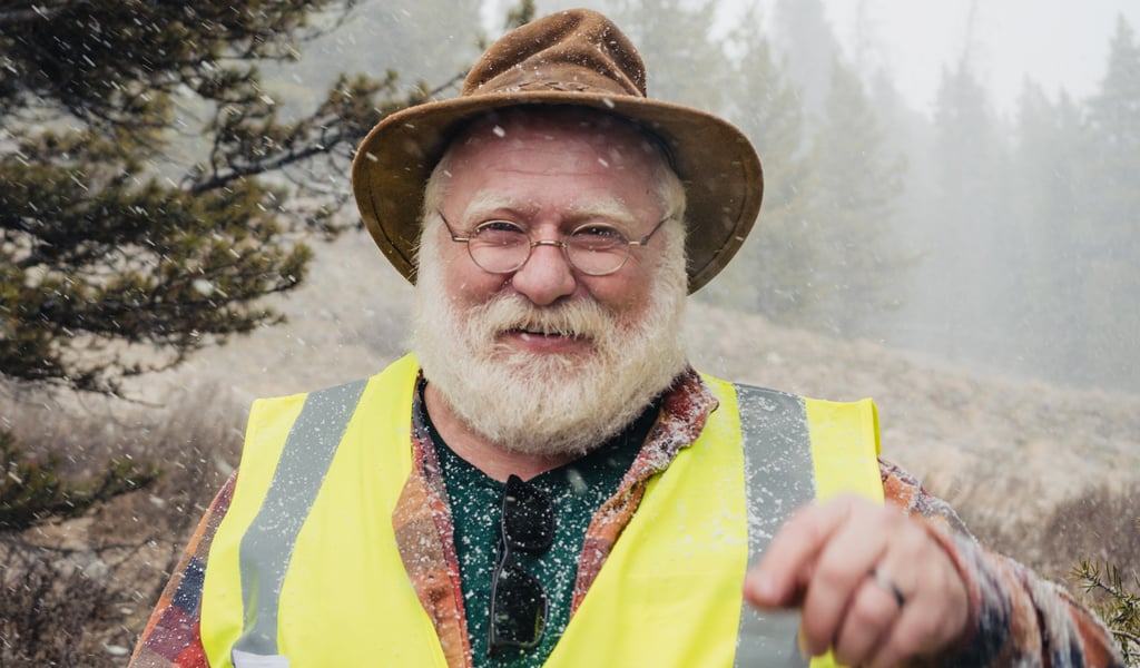 Alex smiling wearing a safety vest.