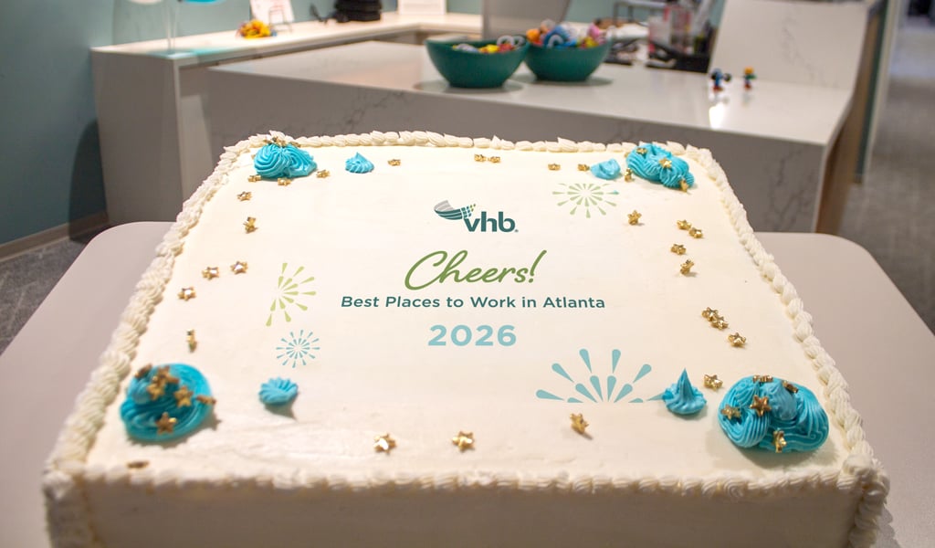 A decorated sheet cake reads, “Cheers! Best Places to Work in Atlanta 2026.” 