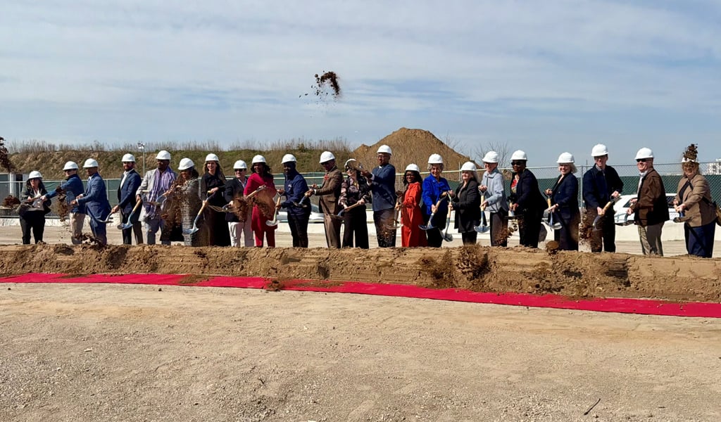 Developers, public agency representatives and project partners pose with shovels at residential groundbreaking. 