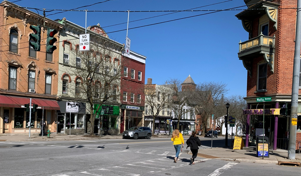 People walking across an intersection in downtown Ballston Spa.