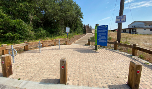 Permeable pavers, bike racks, and signage at the entrance of the 9th Bay Street beach access.