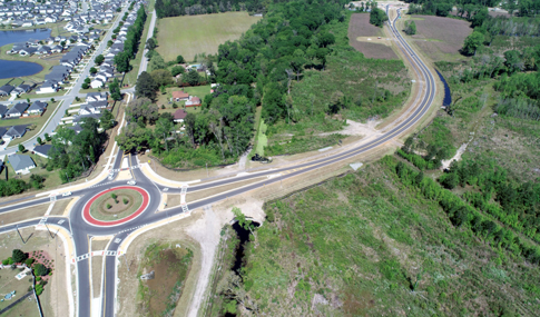 An aerial view of the Benton Boulevard at Meinhard Road roundabout is shown with surrounding neighborhoods.