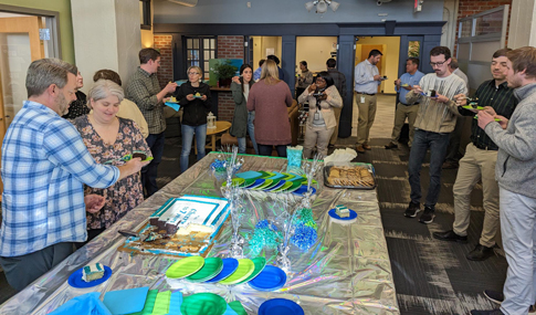 Members of the Richmond office mingling over cake.