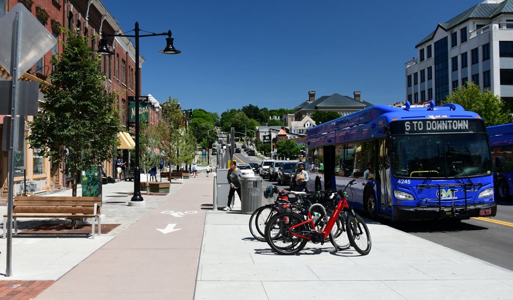 Downtown area with bicycles, buses and sidewalks.