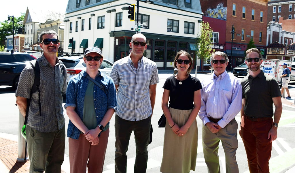 Group of people standing in main street area.