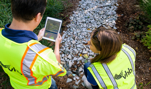 Two water resource engineers collect data in the field. 