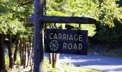 A Carriage Road sign at Acadia National Park that reads, “Carriage Road.”