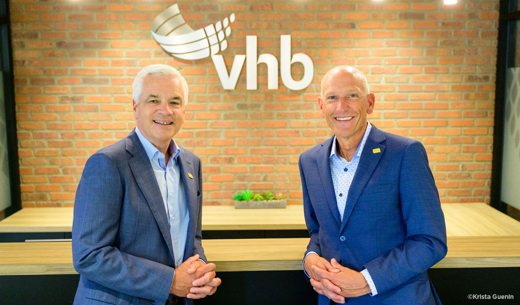 Mike Carragher & Bill Ashworth in front of brick backdrop and VHB logo.