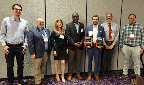 Charlie Townsend stands with his awards around the six VHB employees who attended the ceremony in support.