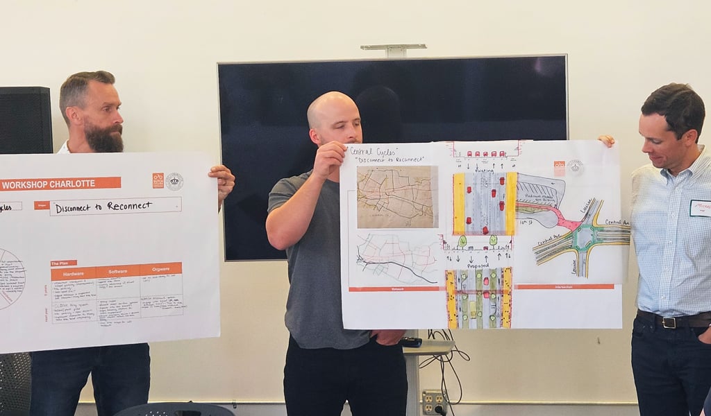 Three workshop participants present final group concepts.