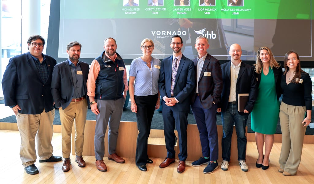 VHB attendees in front of a Climate Week NYC event stage following a panel discussion.
