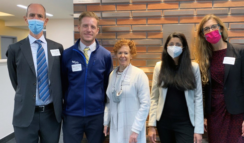 Bryan Murty and event attendees at the ribbon cutting.