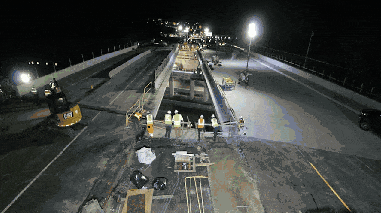 A new bridge is slid into place.