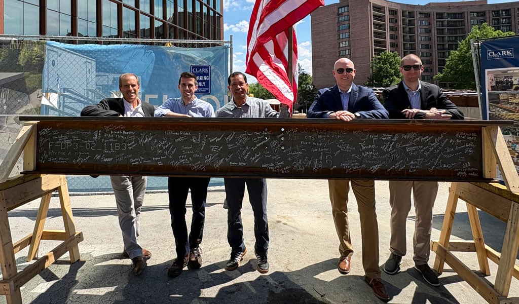 Five VHBers stand with the signed beam.