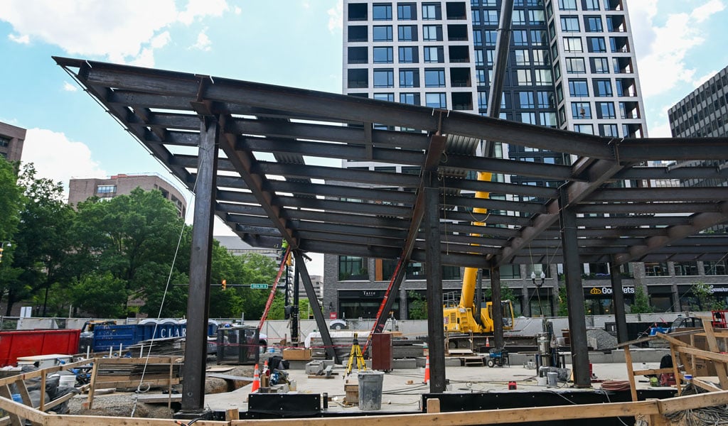 The canopy framing for the station entrance on the active construction site.