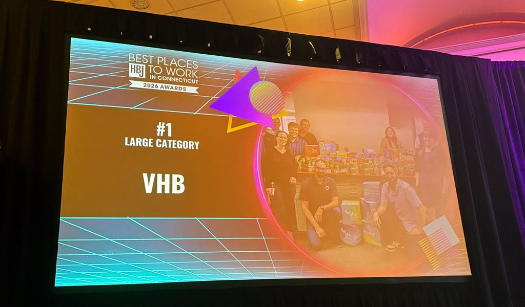 A screen displays "Best Places to Work in Connecticut 2023 Awards." The award presented is "#1 Large Category" to VHB.