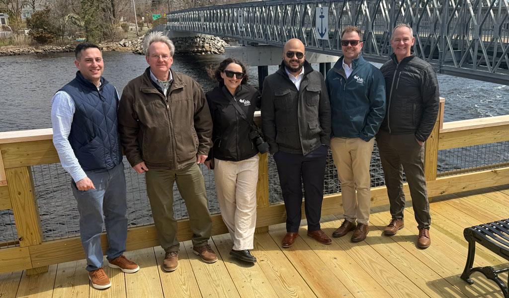VHB’s project team standing on a new riverside fishing platform.