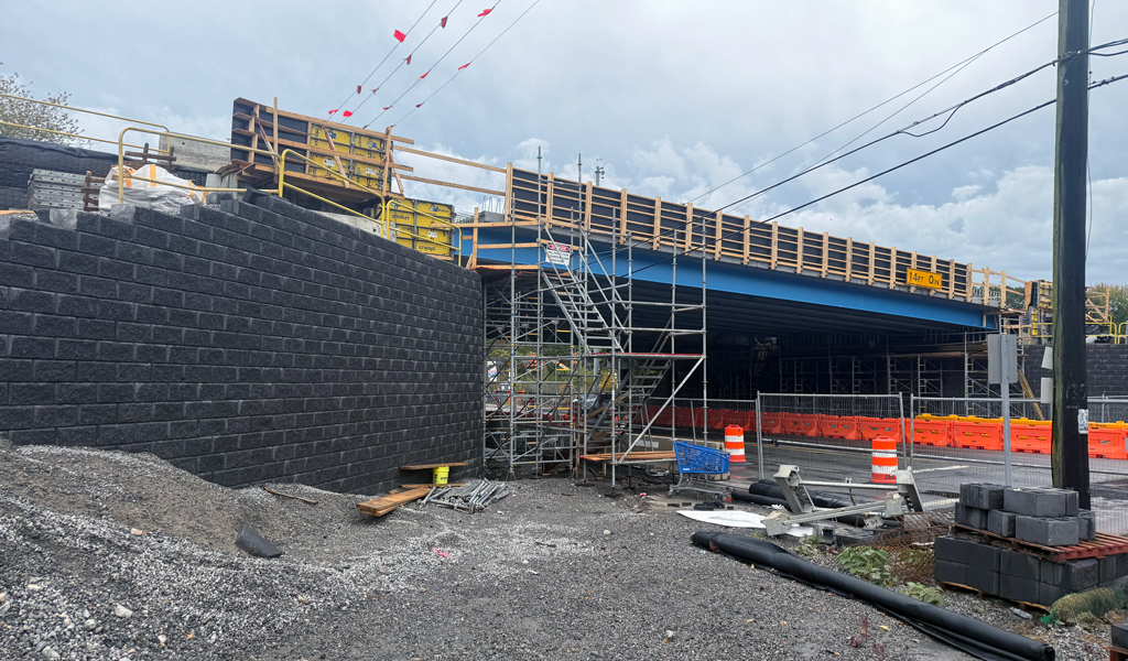 Bridge strengthened with geosynthetic-reinforced soil abutments and a deck under construction.