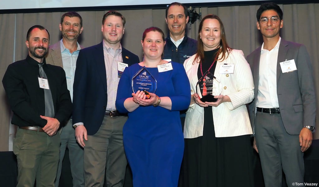 NOON Ingram project team smiling at the camera holding their award.