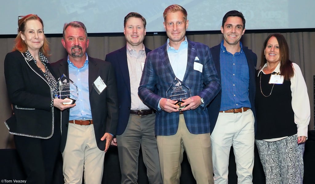 Helios project team smiling together with their award. 