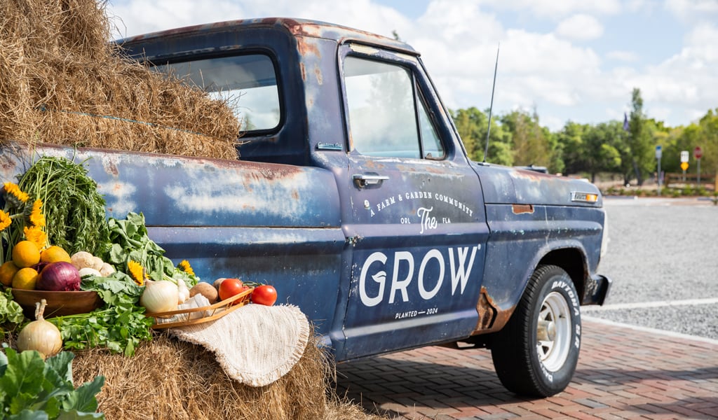 An old truck with the words The Grow painted on the side.