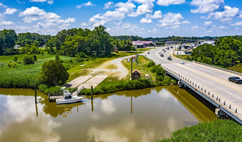 Rendering of the new park site that shows the meandering board walk, larger boat dock, and commercial spaces.