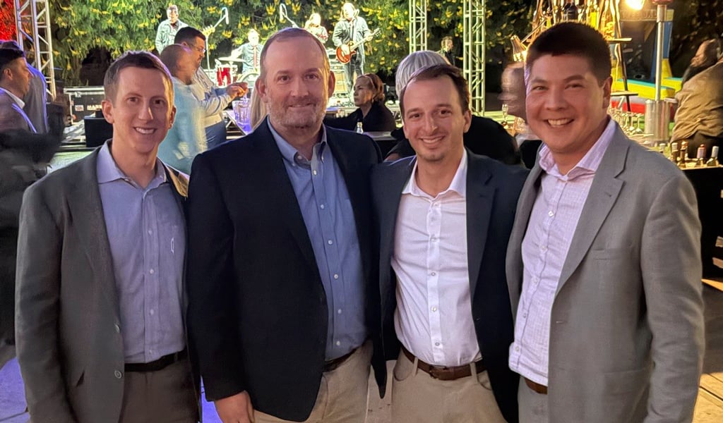 Peter Doster, Rick Dupuis, Jon Moser Andree Nee outside at dusk at the ICSC Conference.