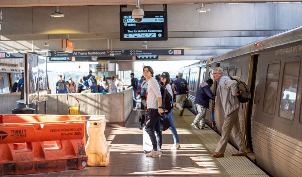 People move off and on a MARTA train at the station.