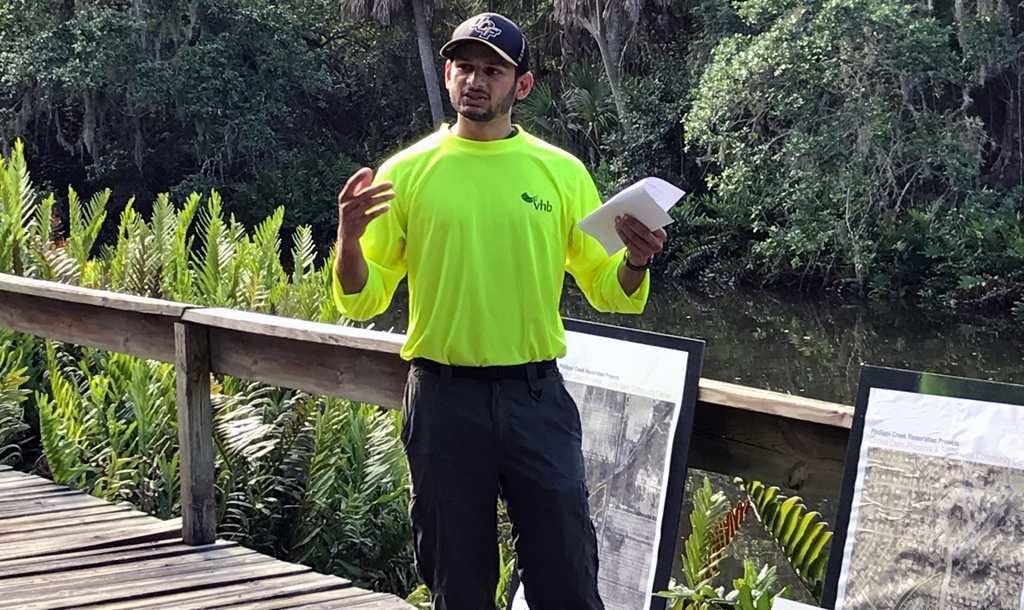 John educating visitors to Phillips Creek in Sarasota about a project to mitigate the negative effects of aged canals dredged below the water table with new vegetation along the banks of the Creek, an effort that will improve water quality downstream and create wildlife habitat.