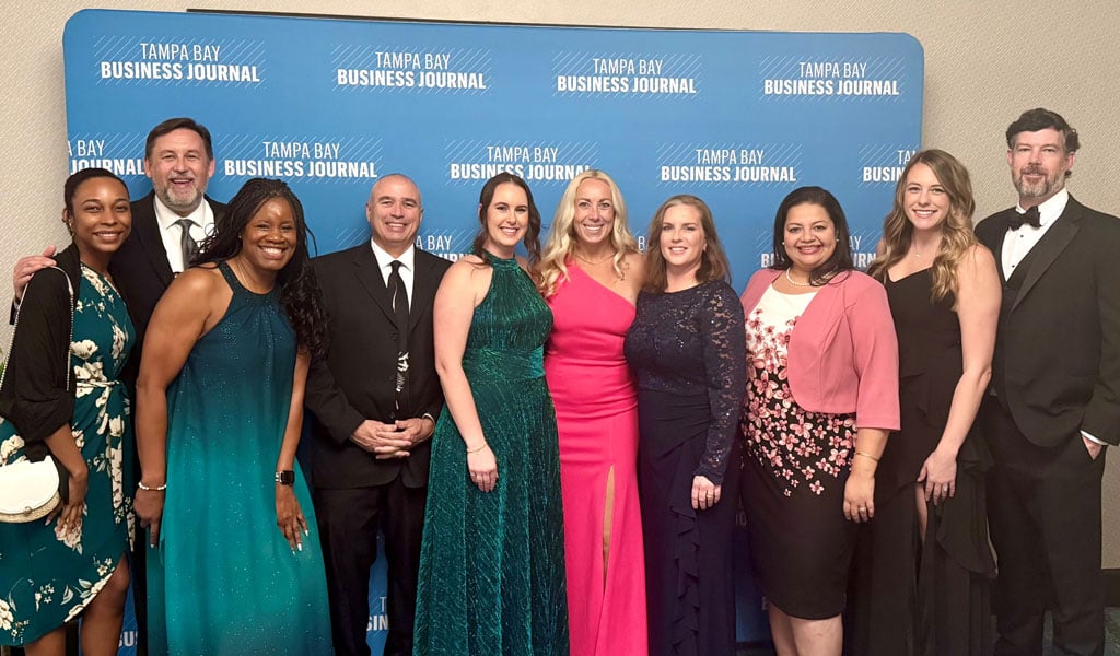 A group of people posing for the camera at the TBBJ event. 