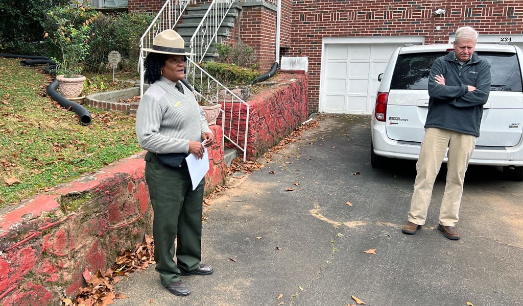A member of the National Park Service stands outside the King Family Home.