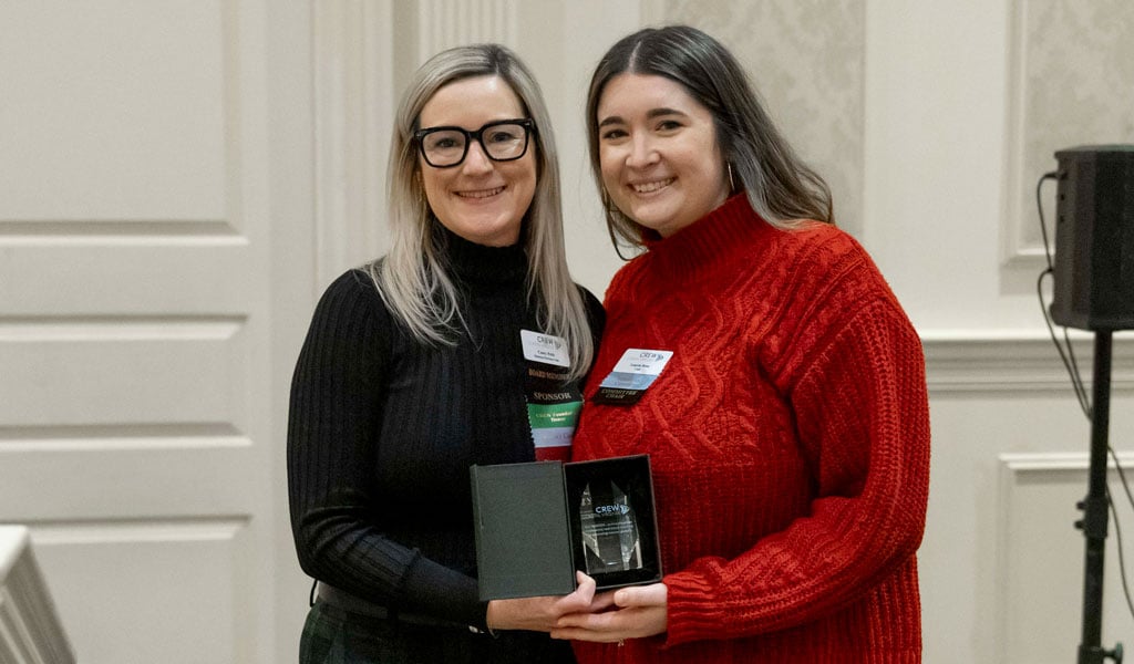 Lauren Rose (right) accepting her award at the CREW Coastal Virginia holiday party in December.