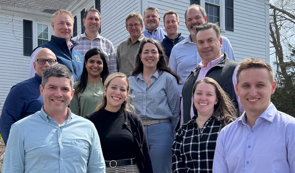 Group photo of Spring 2025 VHB LEADS program participants standing on stone steps outside the Warren Conference Center in Ashland, Massachusetts.