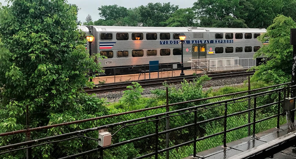 A Virginia Railway Express (VRE) passenger train stopped at a station.