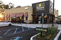 Parking lot in front of a Panera Bread restaurant with an open accessible parking space.