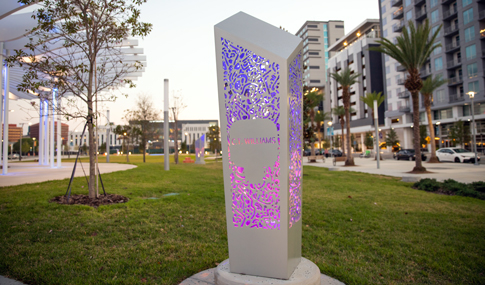 A Luminary Green Park Memorial is light up in purple and pink colors