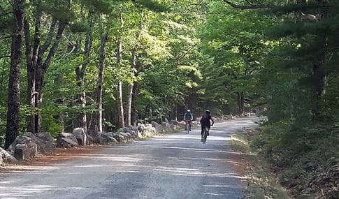 Bicyclists on gravel bike paths in Bethel, Maine.