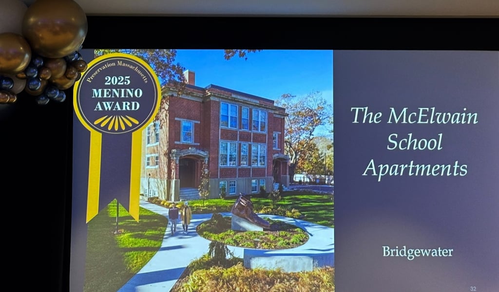 Presentation slide showing "The McElwain School Apartments, Bridgewater" with an image of a red brick building with a lush lawn.
