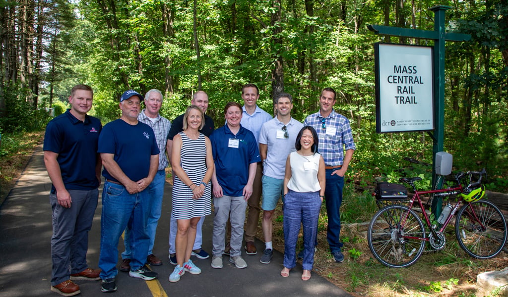 Paved rail trail segment with bridge and natural corridor along the Sudbury-Hudson route.