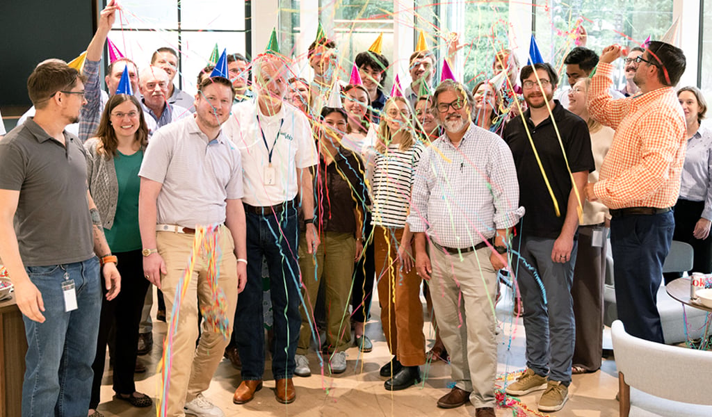 Colleagues celebrating service milestones together at a VHB office event.