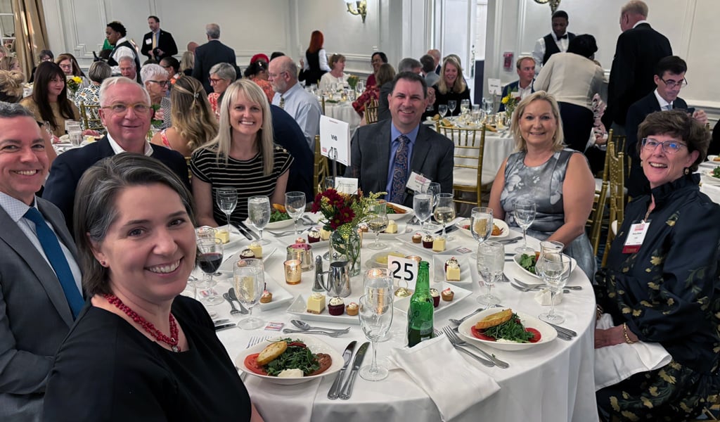VHBers sit at a table together at the Women in Leadership awards ceremony.