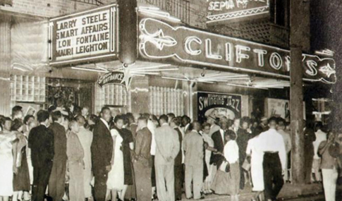 Patrons lined up beneath large neon sign saying “Clifton’s.”