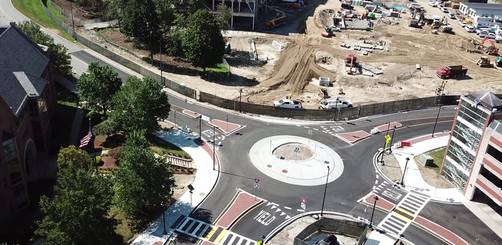 A roundabout with sidewalks at a construction site. 
