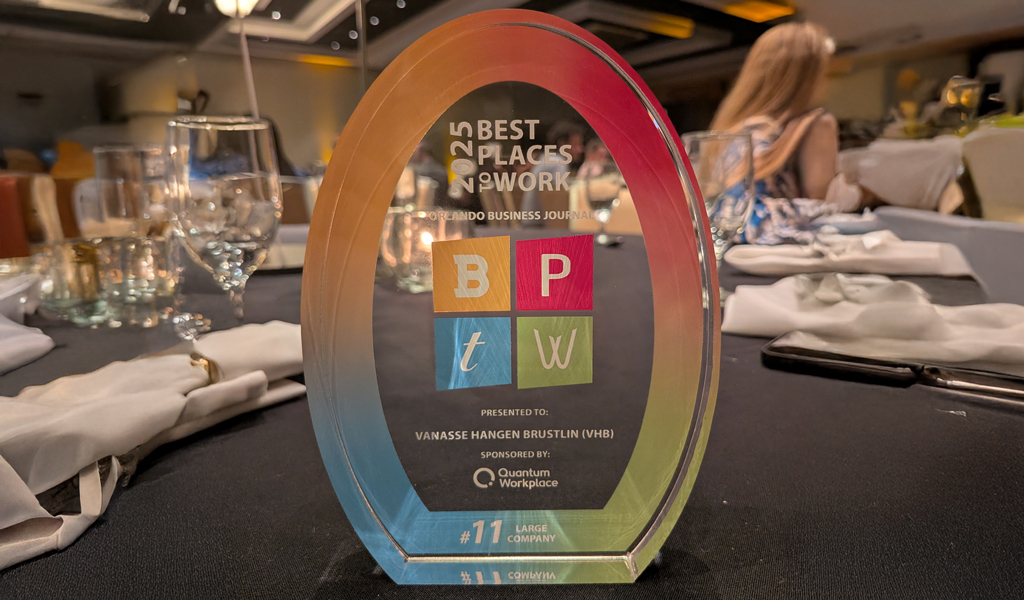 A glass award for Best Places to Work sitting on a table.
